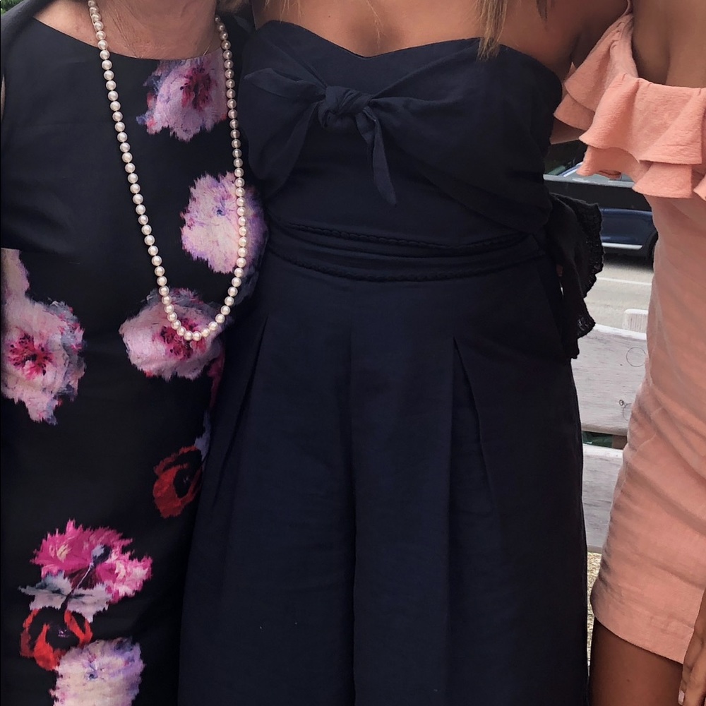 navy blue strapless jumpsuit. bow tie in front